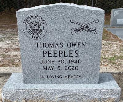 gray granite individual headstone with us army seal and us army cavalry emblems